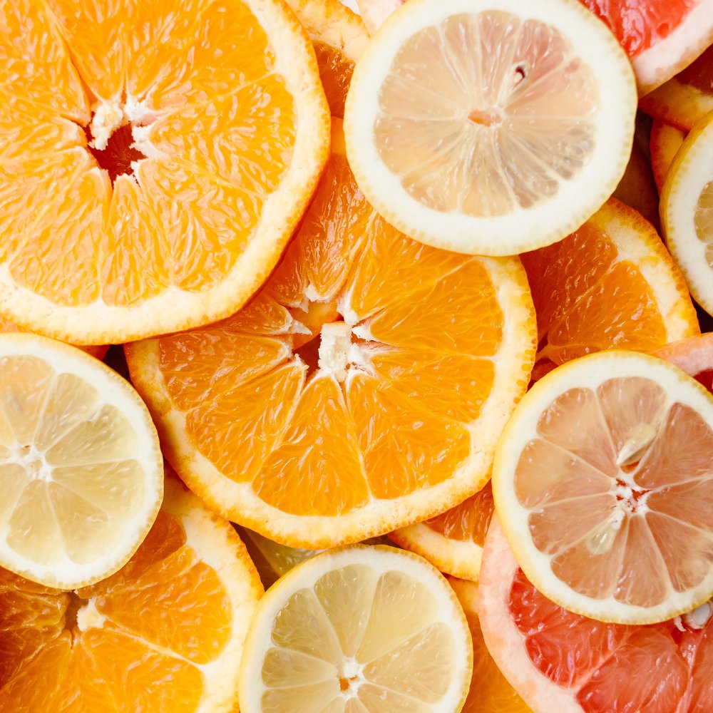 Slices of orange, lemon, and grapefruit overlapping in a colorful, fresh arrangement.